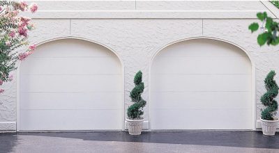 White impact garage doors on a white house