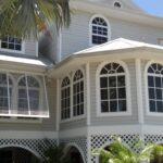 open bahama hurricane shutters on tan house