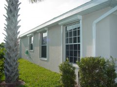 new, white automatic shutters installed on a house in Fort Myers FL