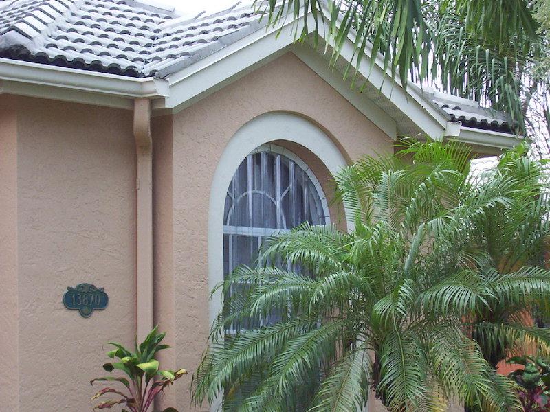 lexan hurricane panels on tan house