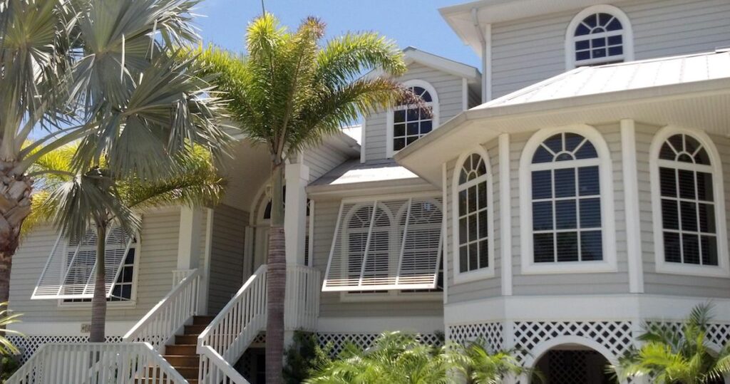 Bahama hurricane shutters over windows of a residential home