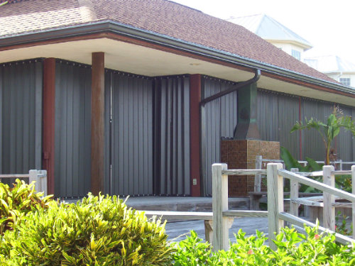 photo of beach house with accordion shutters