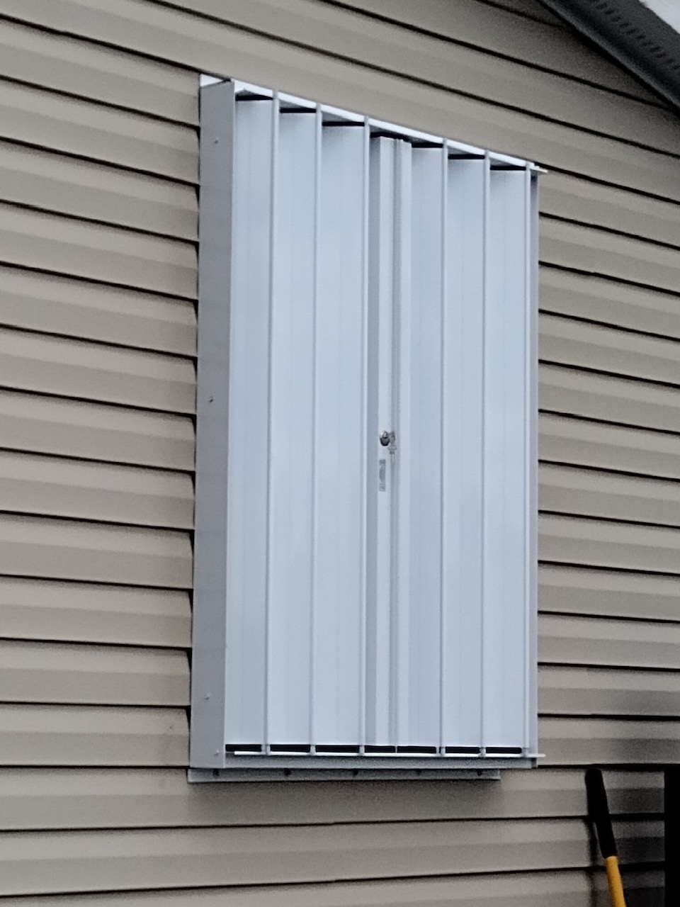 white eurex shutters ptx accordion shutters shown on tan home in lehigh acres fl
