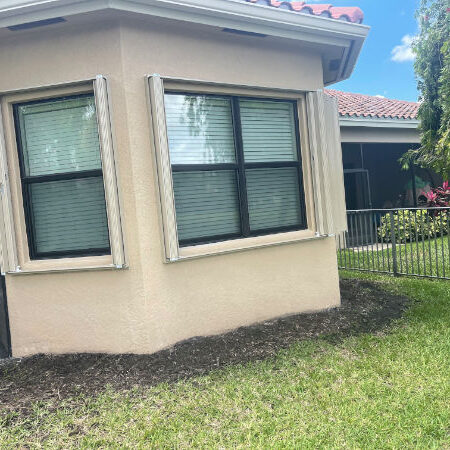 Beige accordion hurricane shutters on a tan home in Fort Myers