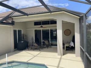Hurricane screens in open position on a tan home in Fort Myers