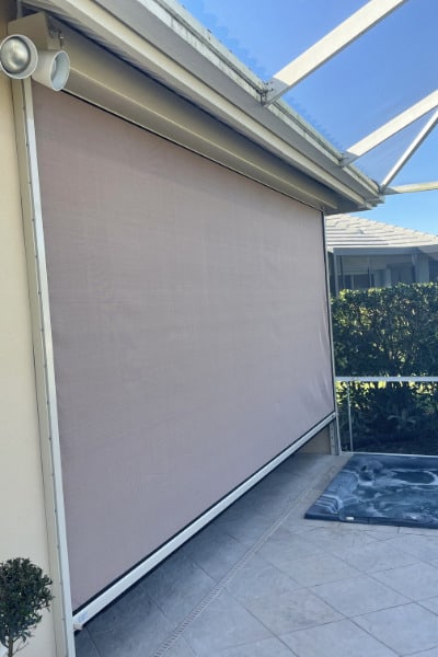 beige Eurex Shutters PTX™ Hurricane Screens on a tan home