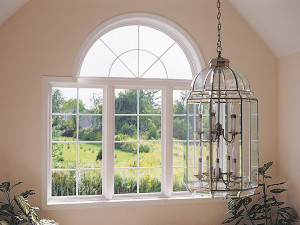 White picture window with arch window on top in a tan room