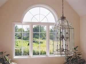 A curved, white, impact picture window looking out to a field.