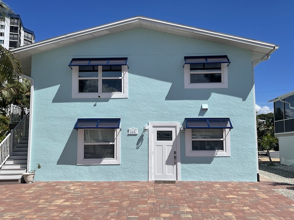 Deco Bahama Shutters on a blue beach home in Fort Myers Beach FL