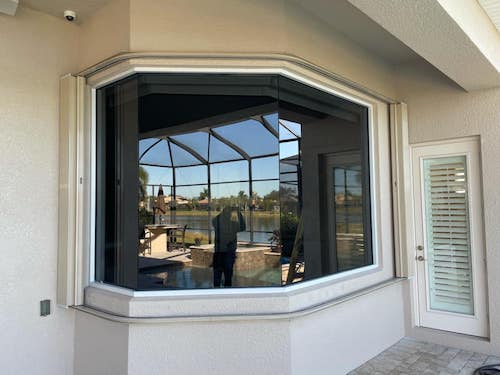 vinyl impact replacement window on a beige home in Fort Myers