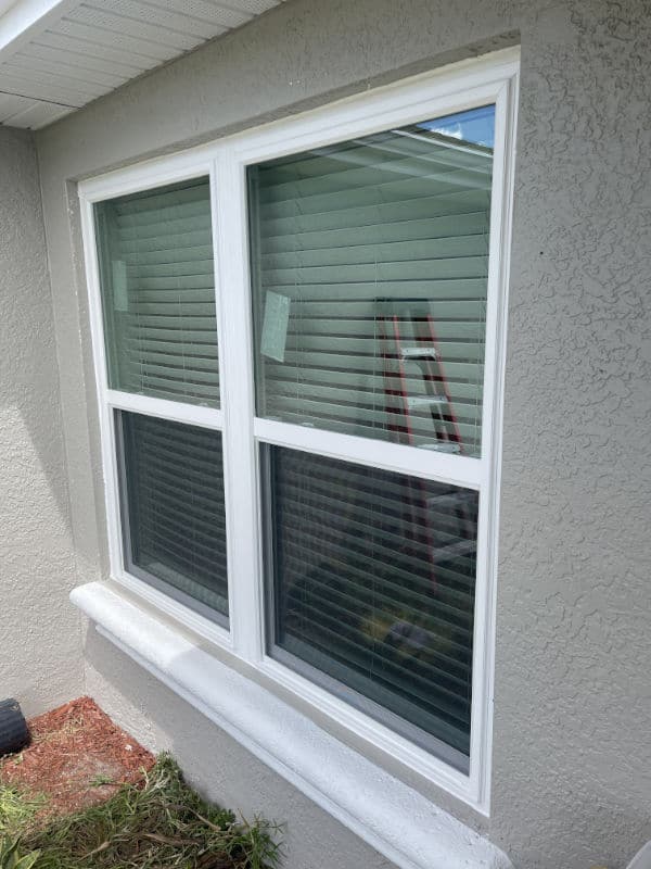 White vinyl replacement windows on a tam home