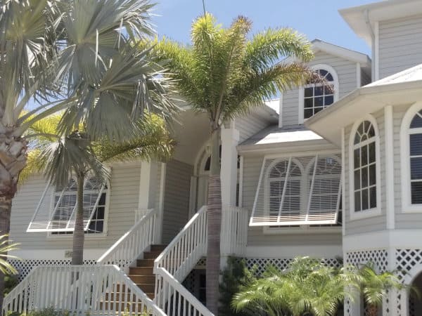 White bahama shutters create the perfect beach feel for this home.