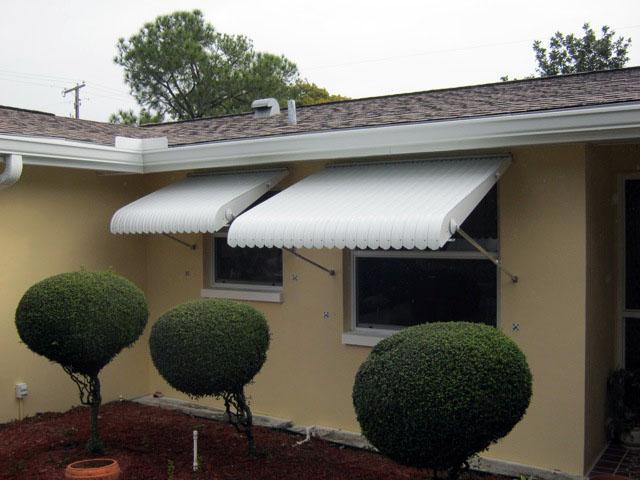 White clamshell shutters go perfectly with this tan home.