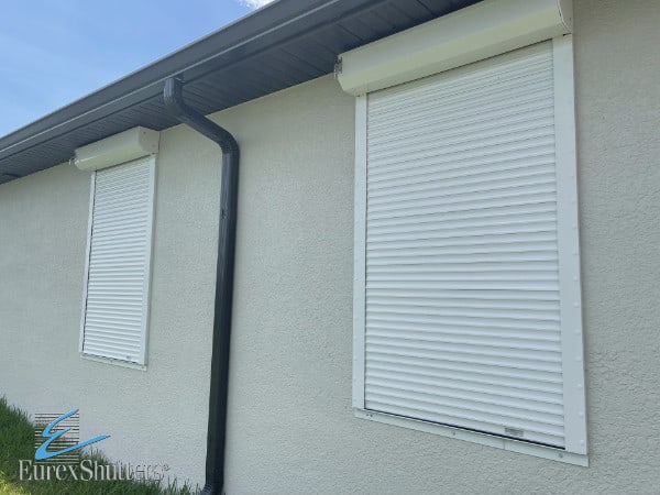 White rolling shutters installed on a tan home in Lehigh Acres FL.