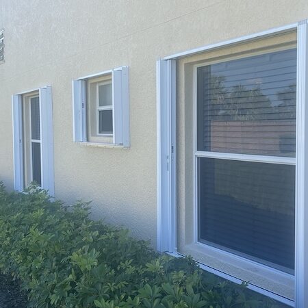 White accordion shutters in multiple sizes, open