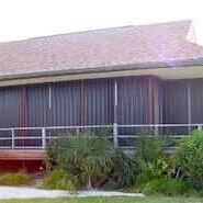 Bronze accordion shutters installed on a beach home in Southwest Florida.