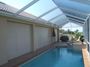 Storm protection hurricane shutters on a patio near a pool