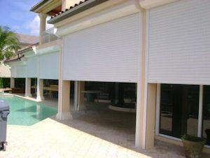 hurricane shutters protecting a patio pool area