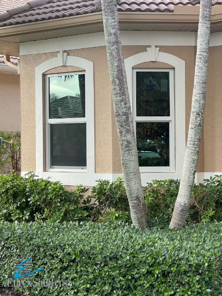 White impact windows without grids shown on a tan home in Florida. 