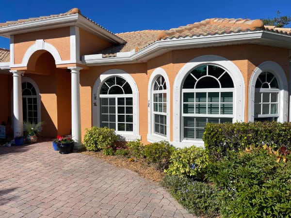 White, vinyl double hung, casement and half moon (arch) impact windows installed on a home in Naples Florida.