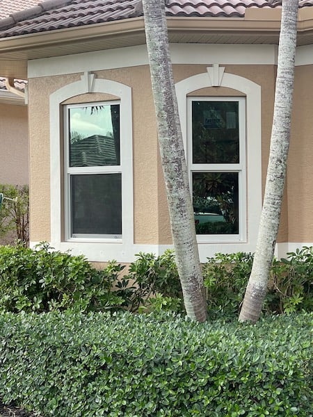 White, vinyl impact windows installed on the front of a home in Naples Florida