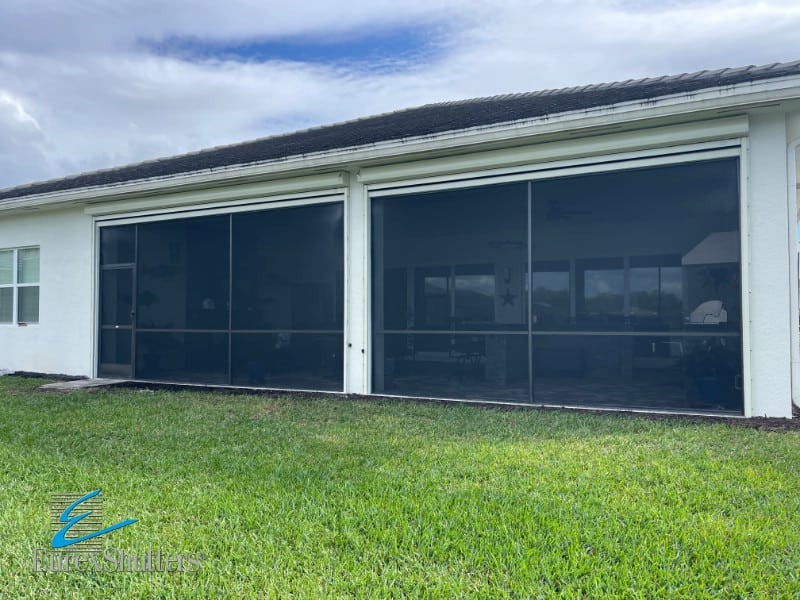 Black hurricane screens with ivory tracks and housings in the open position on a home in Bonita Springs FL