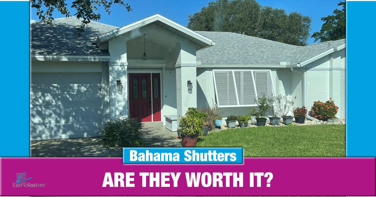 White bahama shutters on a green home