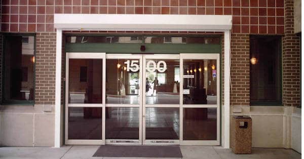 Commercial rolling shutters installed on the doors of an office building for security and hurricane protection.