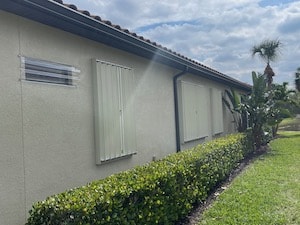 aluminum accordion shutters on a beige home in fort myers fl