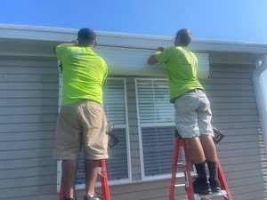 Eurex Shutters hurricane shutter installation team installing Eurex Shutters Roll Down Hurricane Shutters on a home in South Fort Myers FL