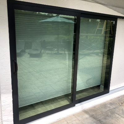 Sliding glass door replacement with impact glass sliding door