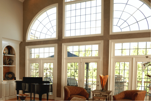 A home with a range of picture windows in different sizes, shapes, and orientations.
