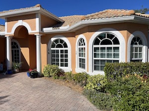 Double hung windows installed with arched windows above them on a home in Naples FL