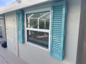 Colonial shutters in custom tiffany blue installed on a home in Venice Florida.