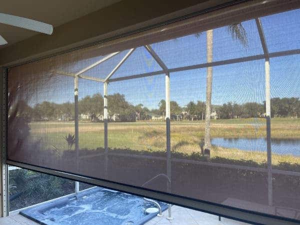 View from inside of a patio looking out through an aramid hurricane screen. 