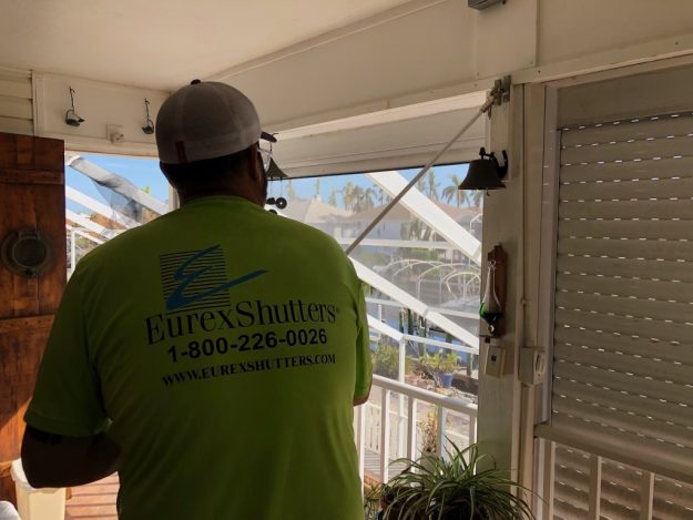 Hurricane shutter repair tech testing roll down shutters