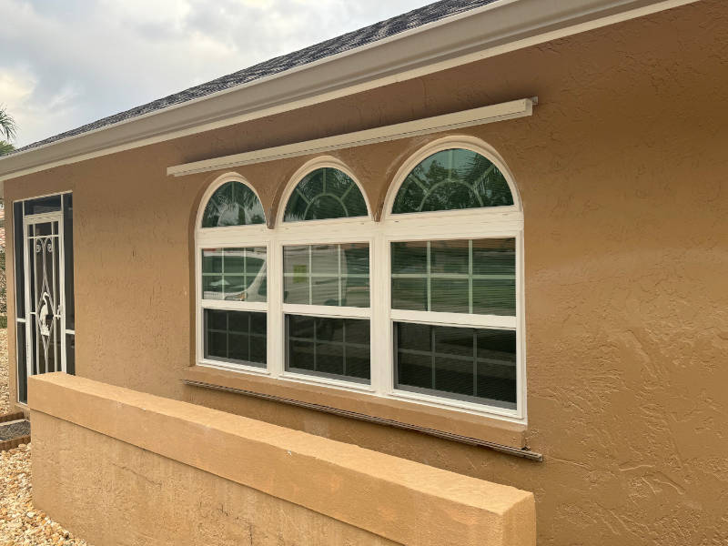 White hurricane proof windows with grilles