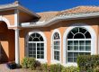 White vinyl windows with muntins and low-e glass on a home