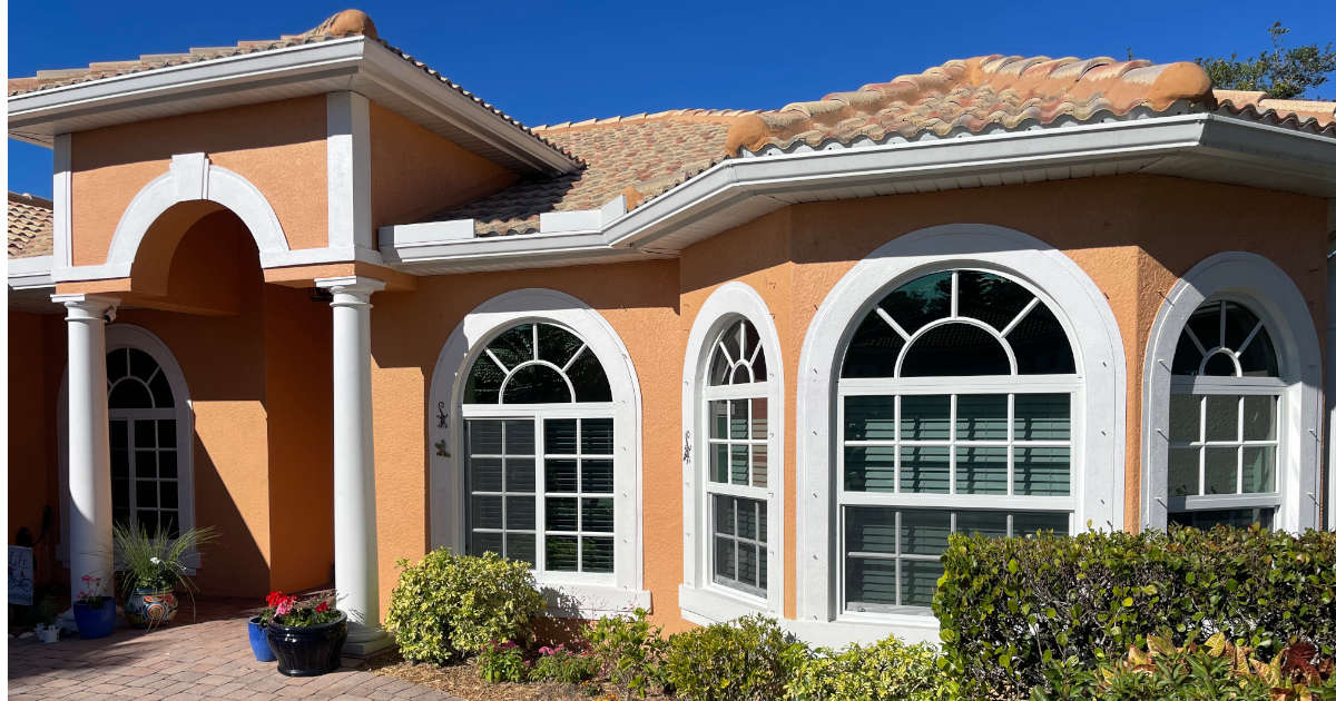 White vinyl windows with muntins and low-e glass on a home