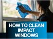 Woman cleaning the inside of impact windows with a microfiber cloth and the words "How to clean impact windows"