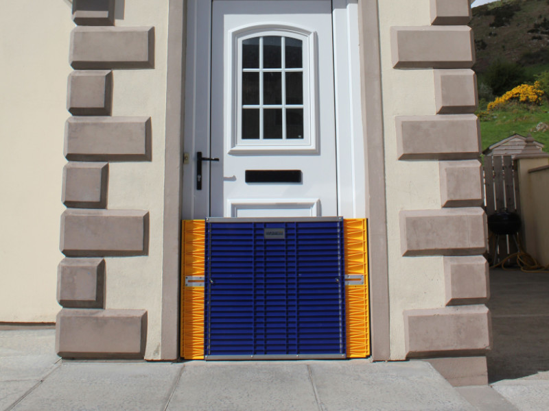 DamEasy temporary flood barrier installed on a home's front entry door.